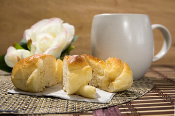 a coffee cup and slices of egg bread on a wooden board