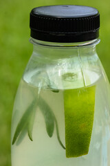 Lemonade in a plastic bottle, a refreshing drink at hot summer day.