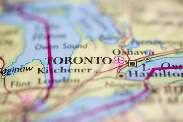 Shallow depth of field focus on geographical map location of Toronto city Canada America continent on atlas