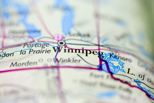 Shallow depth of field focus on geographical map location of Winnipeg city Canada America continent on atlas