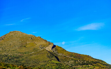 mountain landscape with blue sky and moon