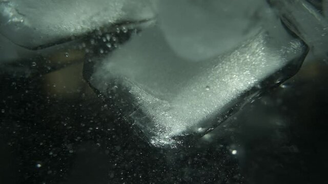 Ice cubes bubbling in a glass of water