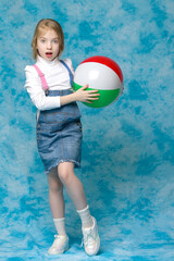 Little girl is playing with a ball.The concept of children's spo