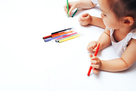 Talented children draw with colored felt-tip pens on white paper, lessons, tasks with children of the different ages