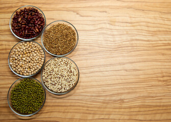 Cereals for proper nutrition on a wooden background, spelled on plates.