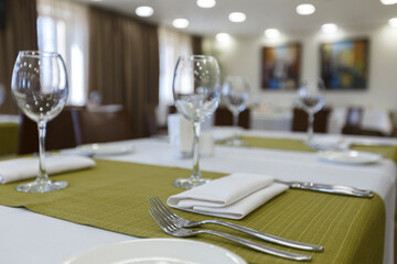 Focus on wine glasses on table in restaurant