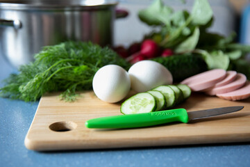 products ingredients for okroshka, summer soup or salad on a wooden background