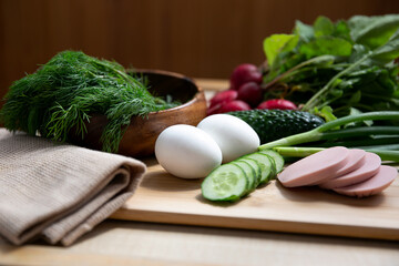 products ingredients for okroshka, summer soup or salad on a wooden background