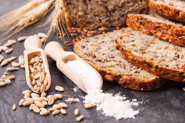 Wholegrain bread, ingredients for baking and ears of rye or wheat grain