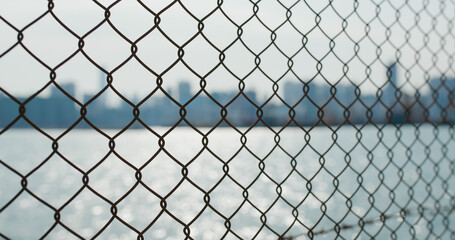 Fototapeta premium Metallic fencing at seaside in evening