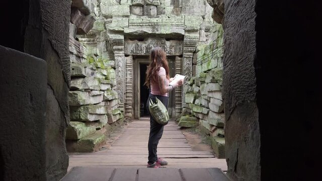 girl young tourist getting lost on famous angkor wat stone temple in cambodia wild jungle