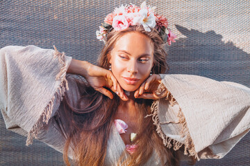 beautiful young woman wearing wreath with flowers outdoors portrait