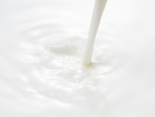Fototapeta na wymiar Close up of the milk pouring