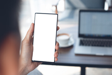 Mockup of man using mobile smart phone in coffee shop
