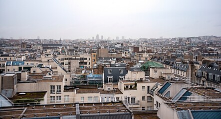 Paris city scape of rooftops. Buildings of Paris from high point of view. Various roofs and houses of Paris