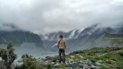 A man walking inside Mount Cook National Park in New Zealand