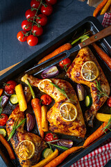 Grilled chicken legs with various vegetables and herbs.