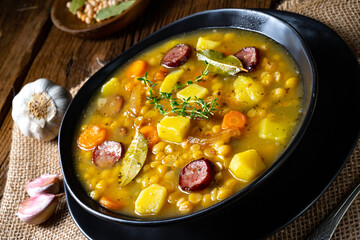 Rustic pea soup with bacon and sausages