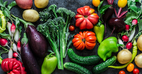 Food banner dark background. Fresh eggplants tomatoes, radishes, peppers, broccoli, potatoes, beets - fresh vegetables, top view. Flat lay