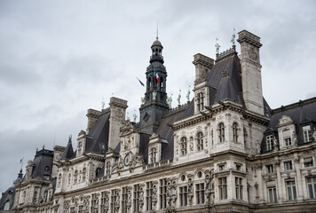 Fototapeta na wymiar Renaissance style gorgeous building with dark roof, chimneys, clock, tower