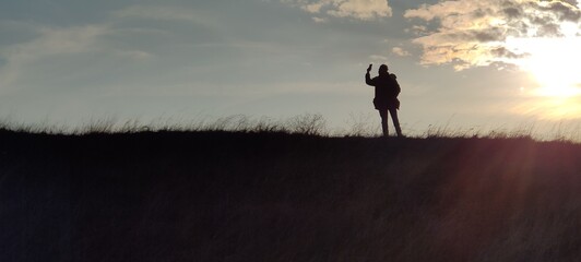 silhouette of a woman in a field