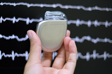This image demonstrates Implantable cardioverter defibrillator (ICDs) on hands - obrazy, fototapety, plakaty