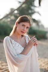 Close-up portrait of a bride looking at the camera. Blond hair. Fluttering hair