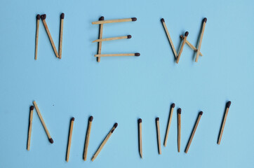 Scattered matches stick on a blue background with copyspace. Top view.
