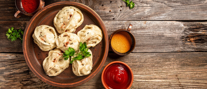 The concept of oriental cuisine. Uzbek food Manti or manty dumplings restaurant concept. Homemade Uzbek dish. recipe background. space for text. top view