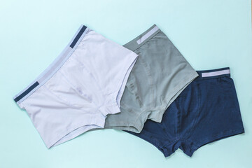 Set of men's underwear on a light background. - obrazy, fototapety, plakaty