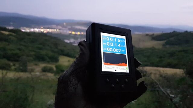 Geiger Counter Radiation Measurement Against Human Settlement At Dusk