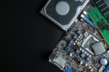 Personal computer motherboard and computer accessories equipment close up on black background with...