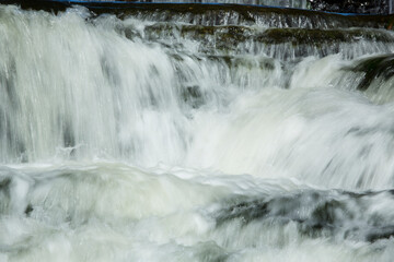 Fototapeta na wymiar Broad Brook cascades over a waterfall in East Windsor, Connecticut.