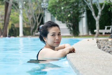 Beautiful Asian woman in swimming pool