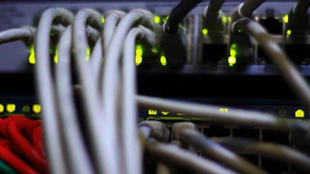 Working Ethernet switch close up. Blinking LED. 10/100/1000 Mpbs speed. Fully loaded and working fast. Top technology clip.