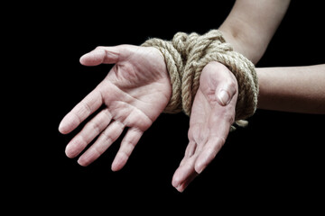 Hands of a victim woman tied up with rough rope. Stop abusing violence concept