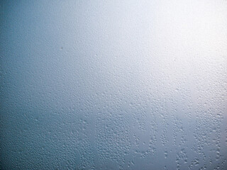 Sunlight breaking through the condensated glass  at a cold early morning.