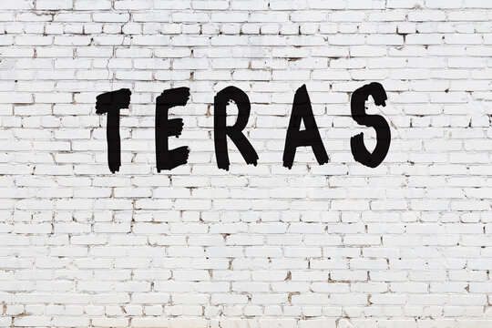 Word teras painted on white brick wall