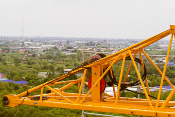 Fototapeta premium The technician removing tower crane from rooftop by derrick crane.