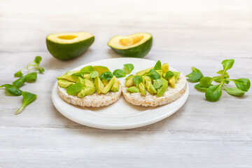 Crispy rice cakes with sliced avocado. Healthy and fresh breakfast. Healthy and vegan concept 