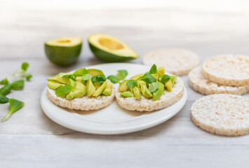 Crispy rice cakes with sliced avocado. Healthy and fresh breakfast. Healthy and vegan concept 