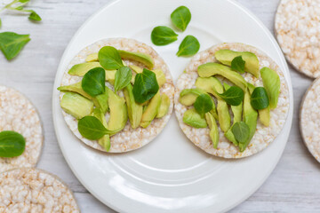 Crispy rice cakes with sliced avocado. Healthy and fresh breakfast. Healthy and vegan concept 