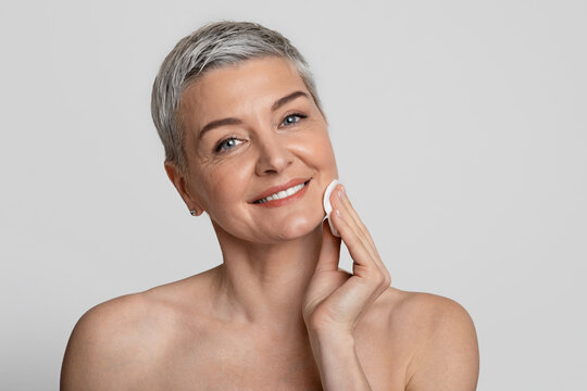 Face Skincare. Beautiful Mature Woman Using Cotton Pad, Cleansing Skin From Makeup