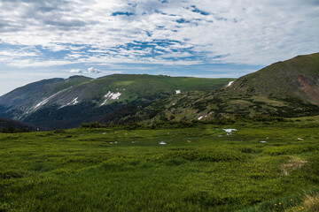 Fototapeta na wymiar mountain landscape with green tundra and overcast sky