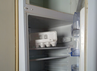 Eggs box in empty fridge