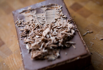 A block of milk chocolate and milk chocolate shavings.