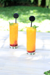 Two Tall Glass of Refreshment on the garden