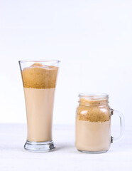 Two dalgona coffee on white table