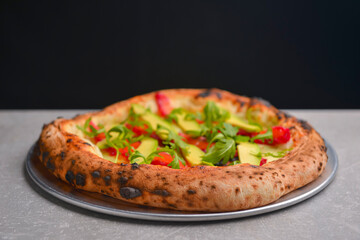 Close-up of a delicious smoked salmon pizza with cheese, avocado and smoked salmon. Sea-food.