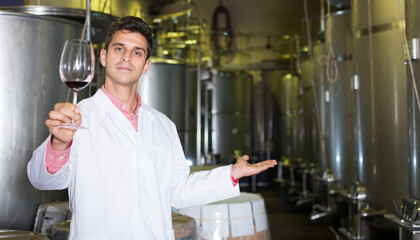 Winery technician posing with wine